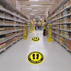 Keep Social Distance, Stand Here Floor Decals in Grocery Store