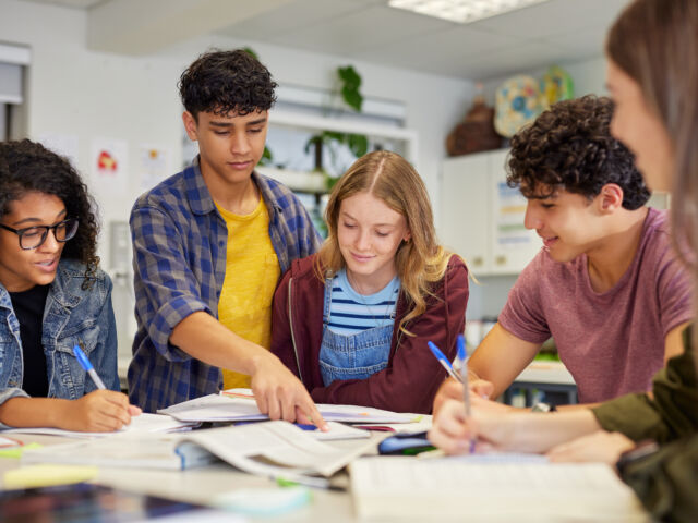Multiethnic students studying together at secondary school